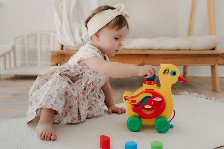Adorable Baby Playing with Colorful Toy Duck