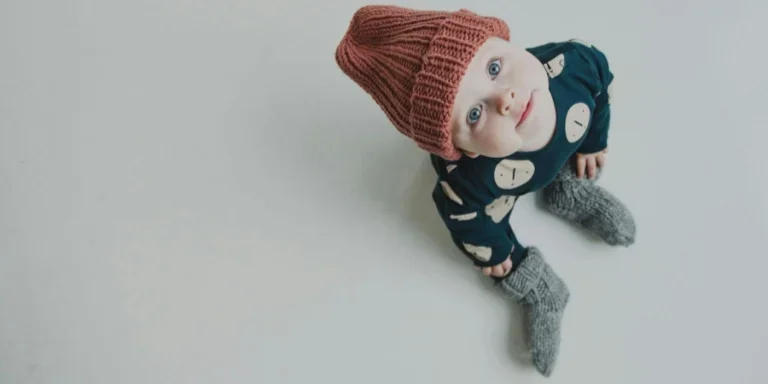 Muñeca bebé con camisa de manga larga azul y blanca