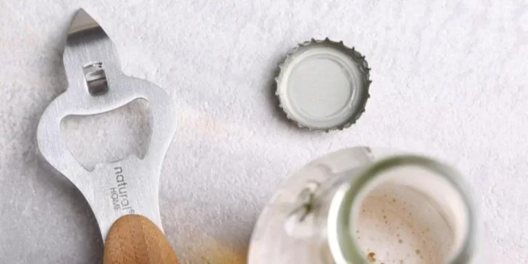 Bottle cap opener next to open bottle