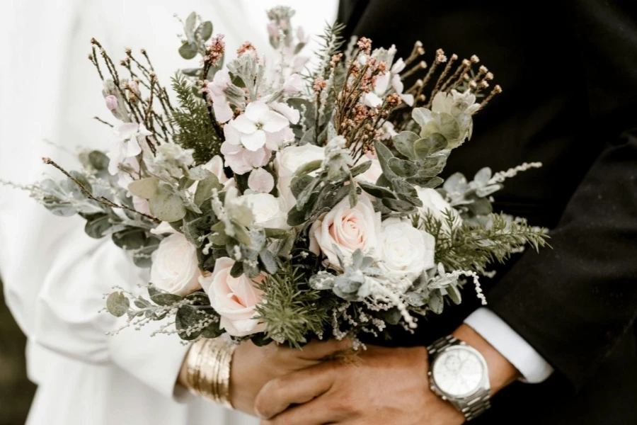Bride And Groom Standing While Holding Flower Bouquet