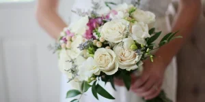 Brides Holding White Bouquet of Roses