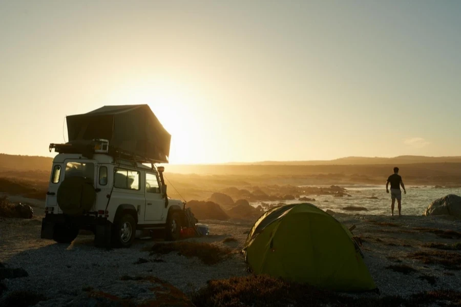 Car Rooftop Tent Against Sunrise Background