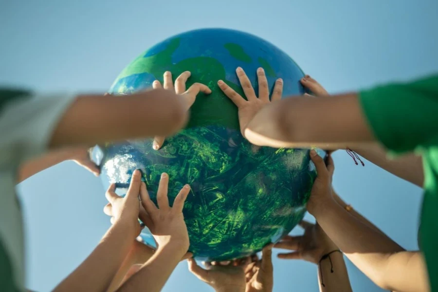 Children holding a planet outdoors