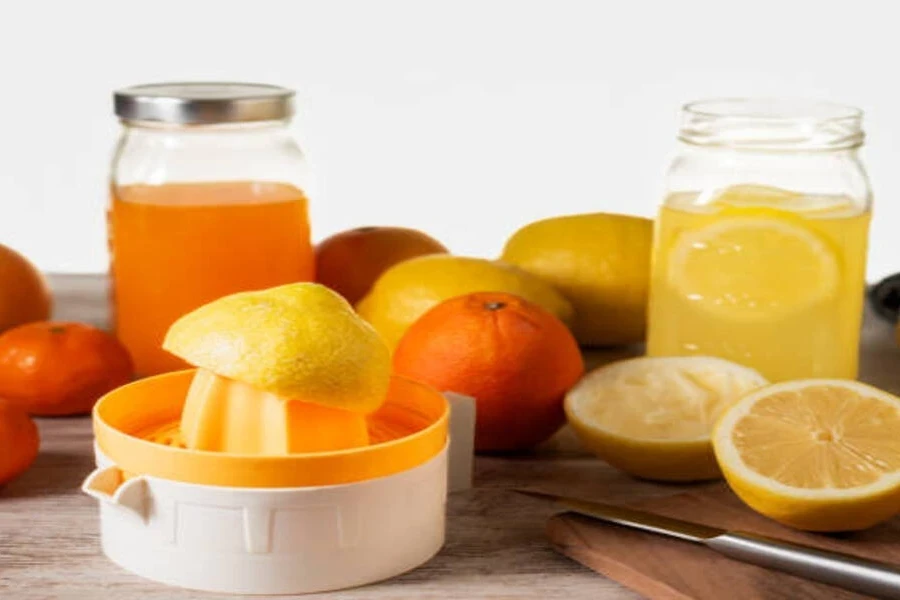 Citrus juicer with oranges and lemons surrounding it