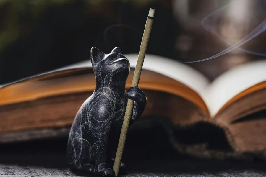 Close-up of a Cat Figurine with a Burning Incense