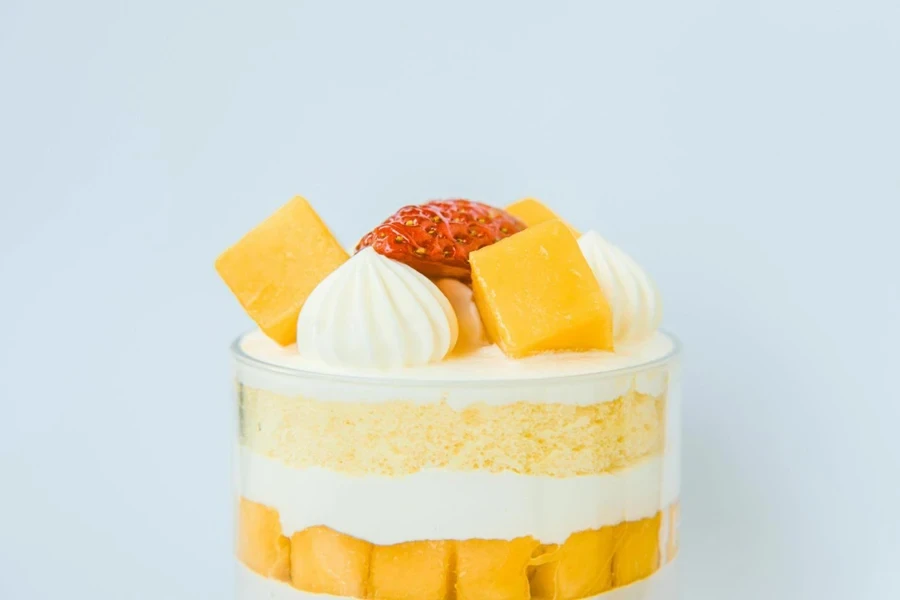 Close-up view of layered cake in a plastic trifle bowl