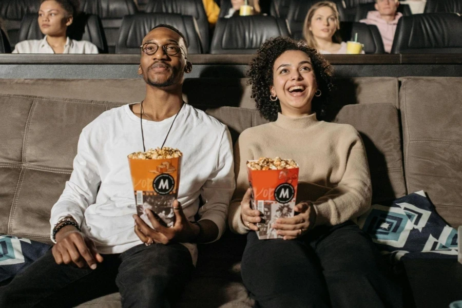 Couple Holding Popcorn Watching a Movie