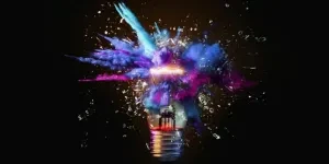 Creative colored light bulb explosion with shards and paint, a creative idea