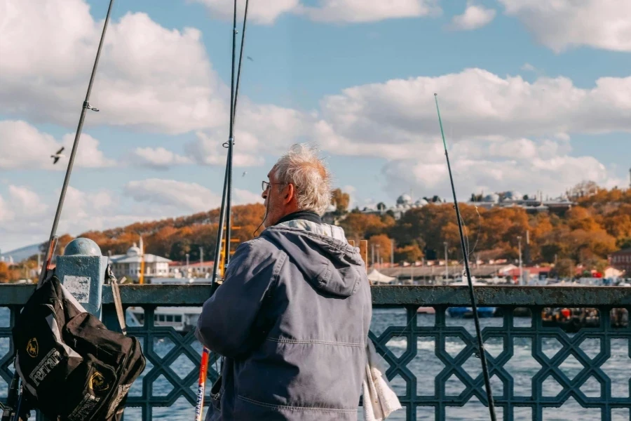 Elderly Man Fishing on a Scenic Bridge