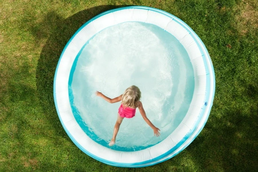 Girl Jumping into Inflatable Pool