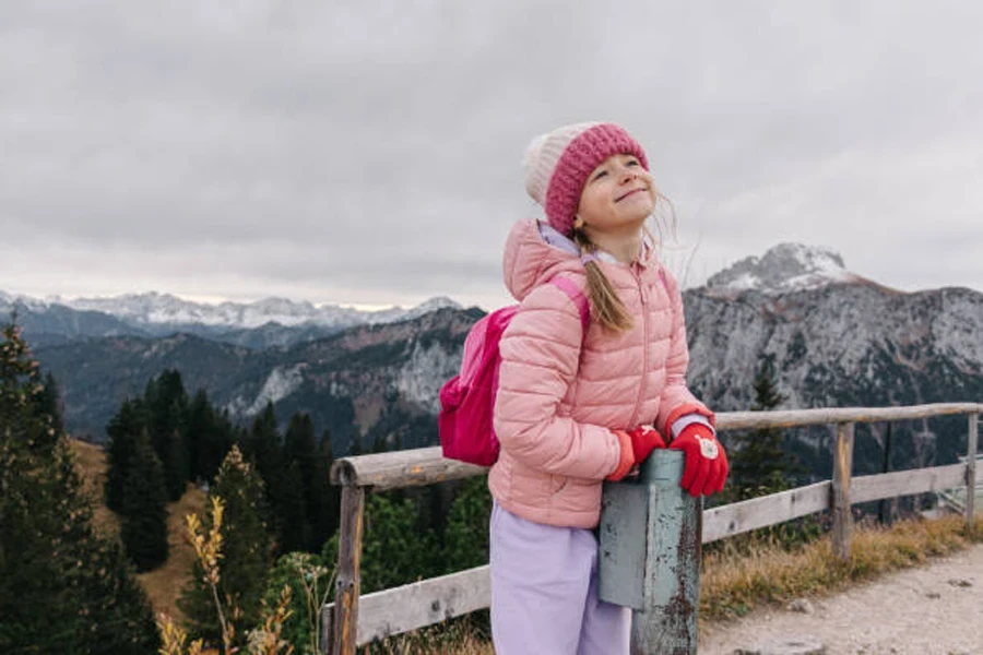 Girl Standing on the Wooden Fence at Mountain