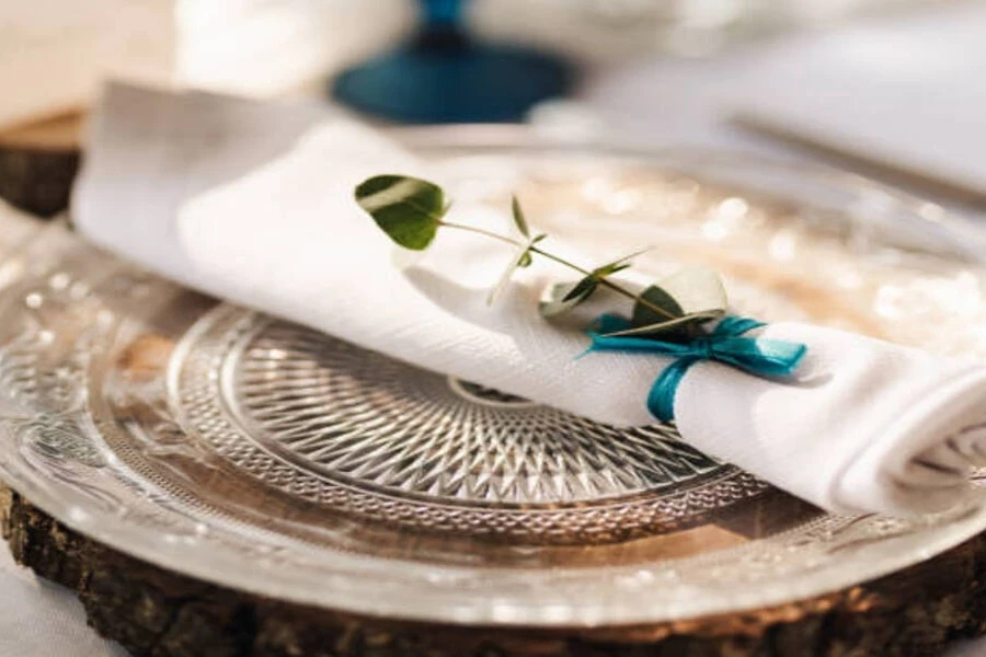 Glass charger plate with delicately detailed rim on table