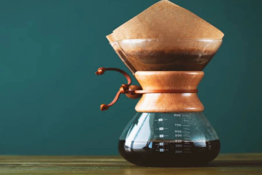 Glass coffee pot with bamboo neck and half coffee inside