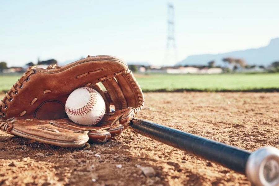 Glove, Bat, and Baseball Gear on Sand for A Game