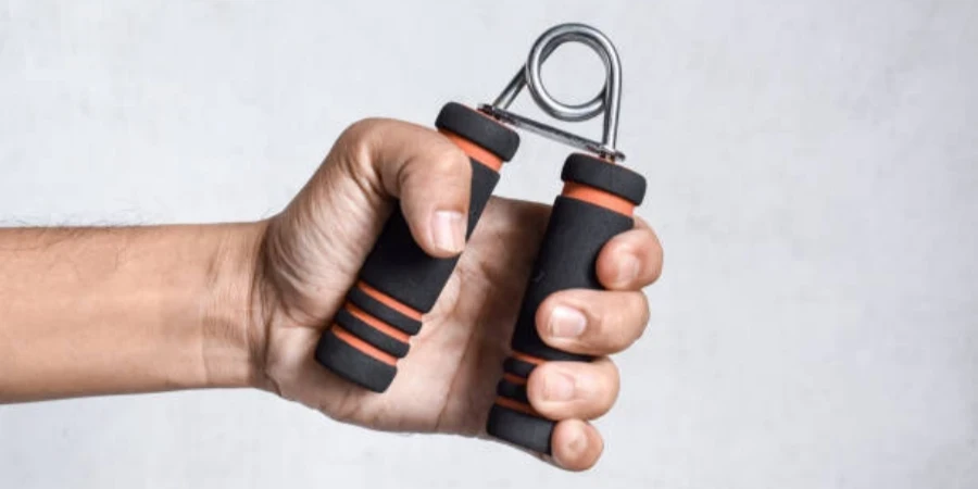 Hand of Southeast asian, Chinese man gripping hand exercise gripper