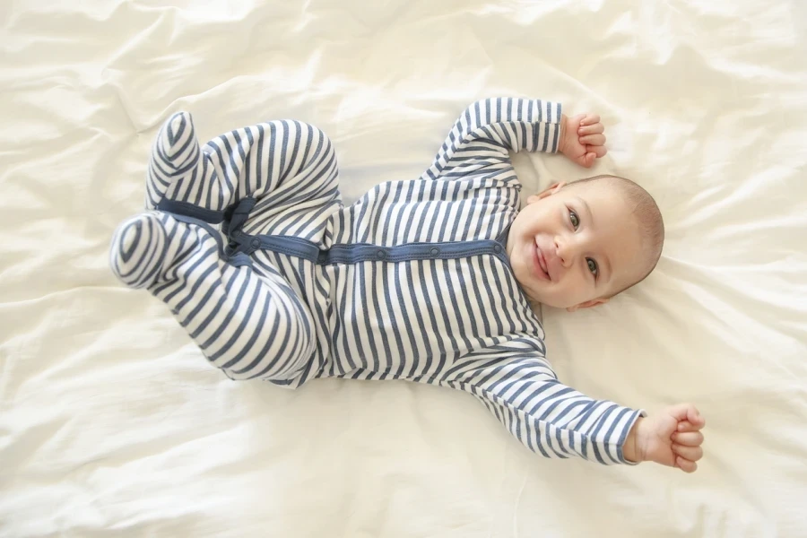 Happy baby on striped white and blue romper