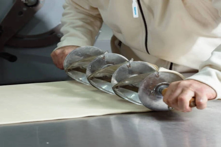 Long piece of pastry dough with commercial pastry cutter