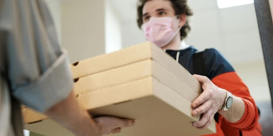 Man Wearing a Face Mask Delivering Pizza