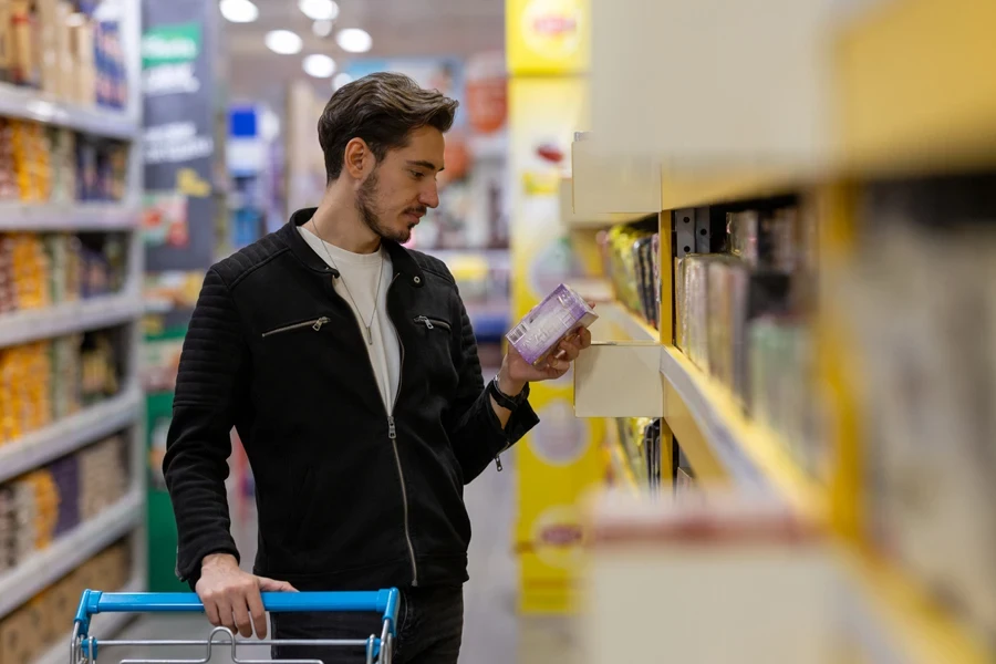 Man checking the contents of packaged foods