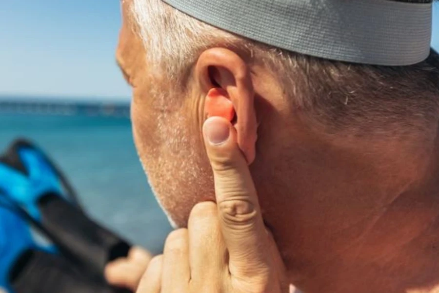 Man putting in silicone earplugs