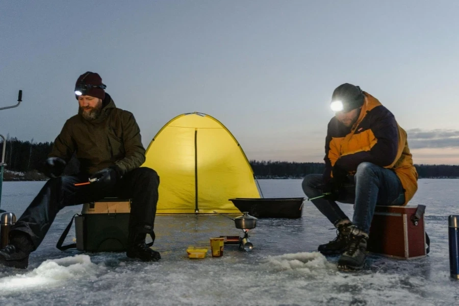 Men Sitting on Frozen Lake Fishing