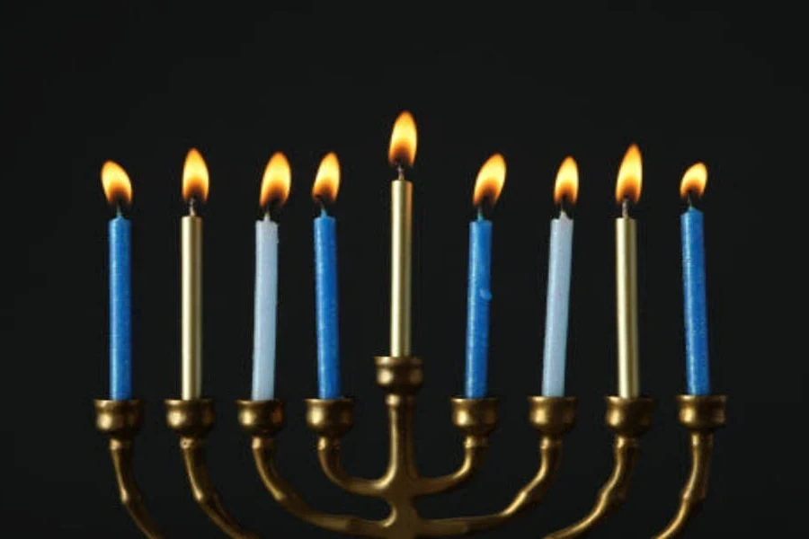 Metal menorah with light blue candles for Hanukkah