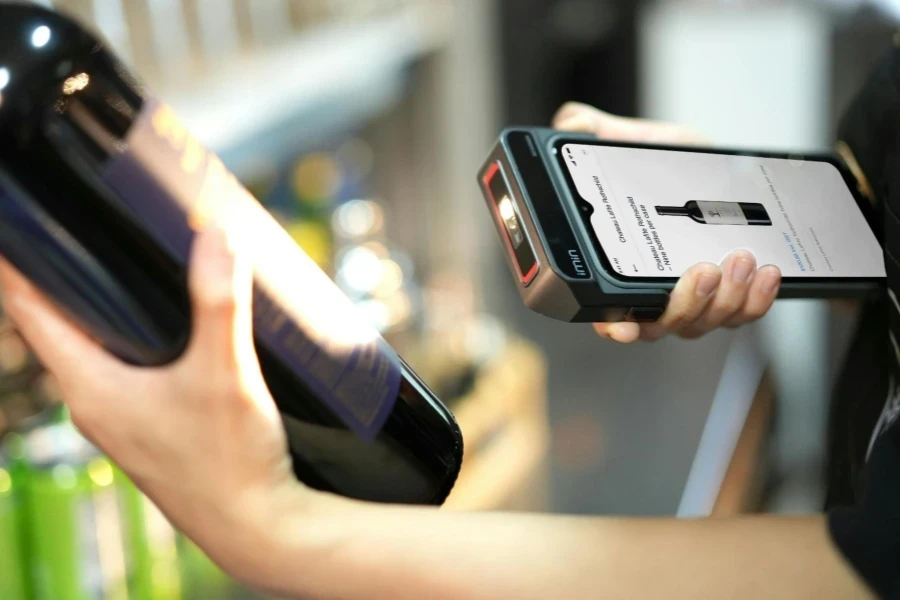Person Using Scanner on Bottle of Wine