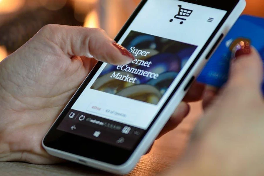 Person holding smartphone and making payment