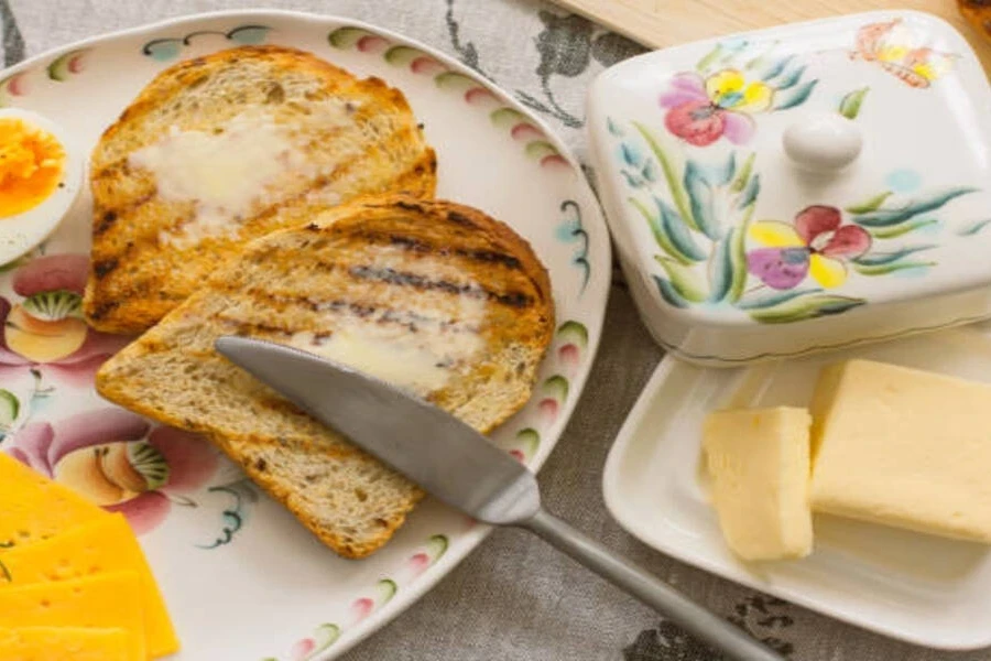 Porcelain butter dish with floral design next to food