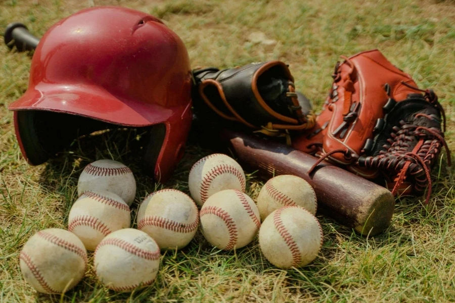 Red Baseball Helmet on Green Grass Field