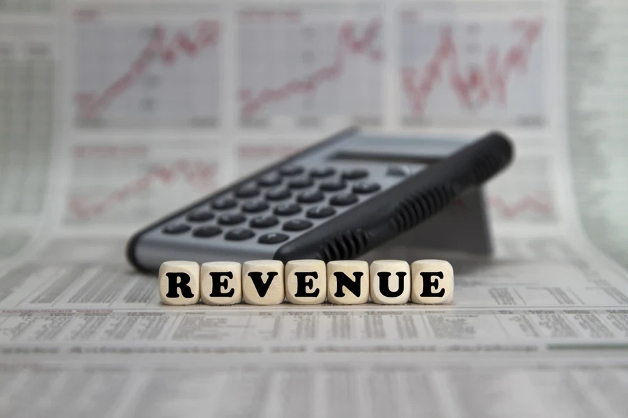 Revenue on word blocks next to a calculator