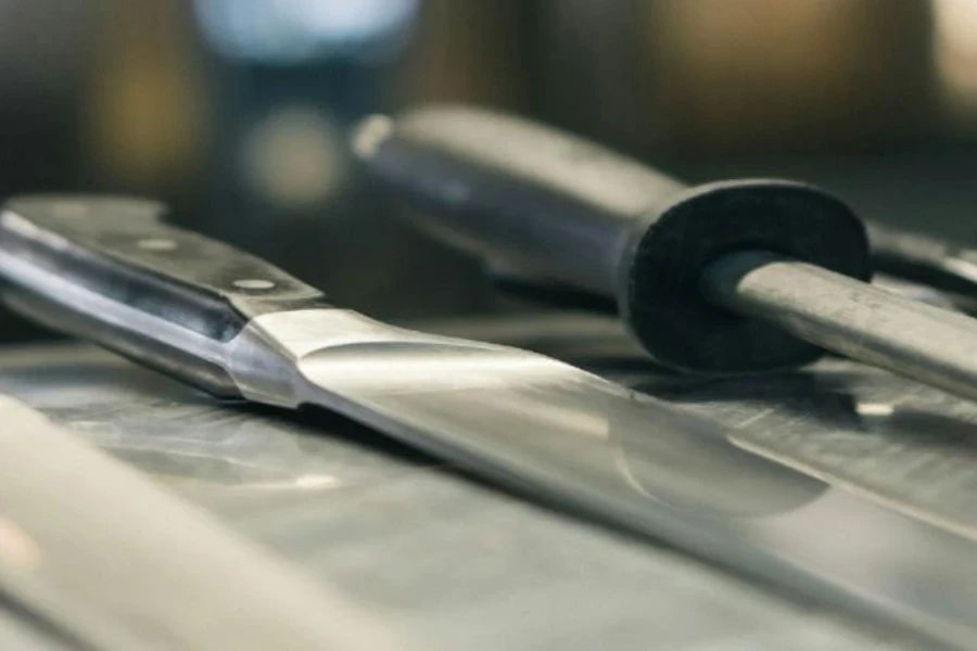 Set of knives next to a steel honing rod
