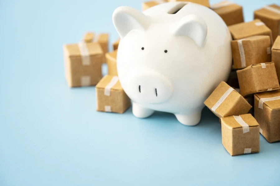 Shipping boxes surrounding a piggy bank