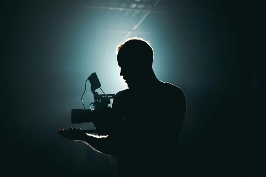 Silhouette of Man Standing in Front of Microphone