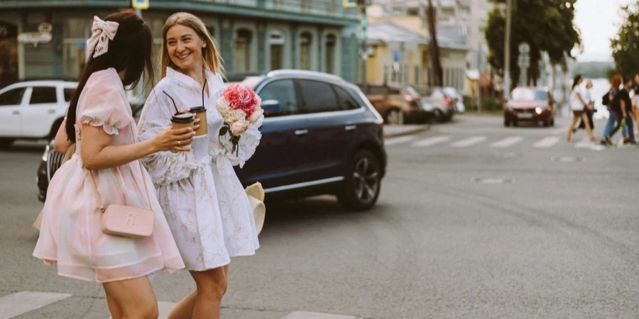Smiling Girls in Fancy Dresses Walking on Street
