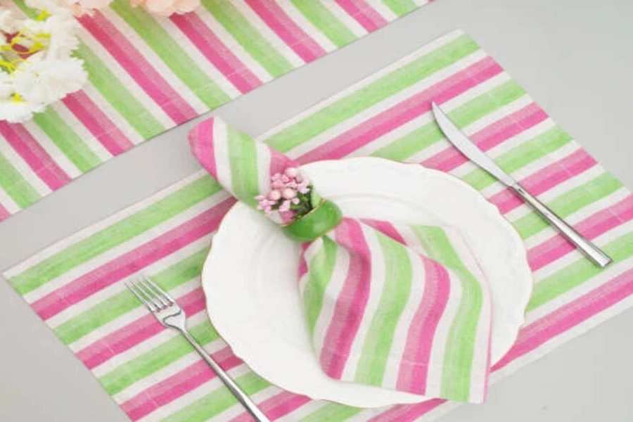 Striped pastel-colored cotton table mats in green and pink