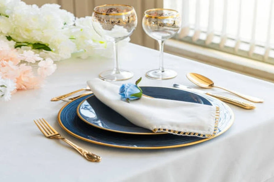 Table at wedding with white tablecloth and fancy tableware