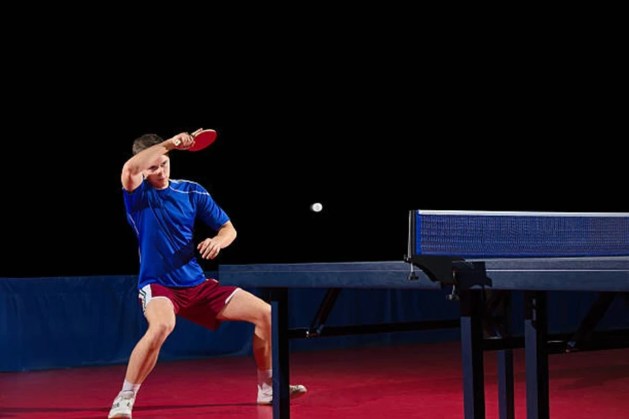 Table tennis player isolated on black