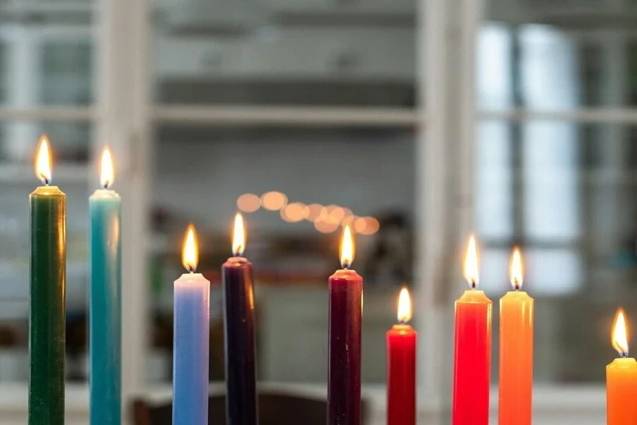 Thin wax candles in different colors on Second Night