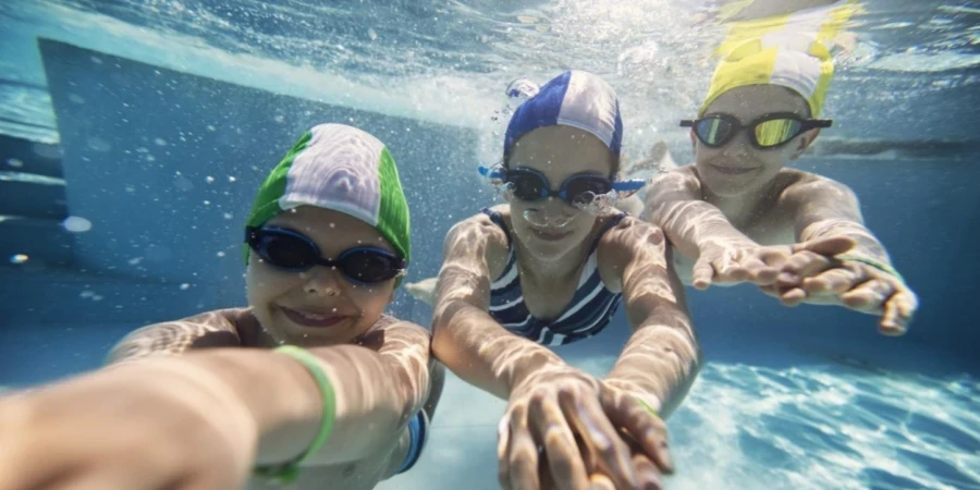 Three Happy Kids Swimming Underwater