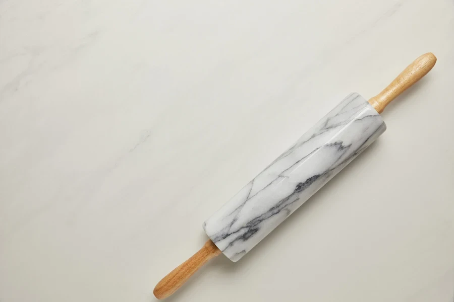 Top view of marble rolling pin on white background