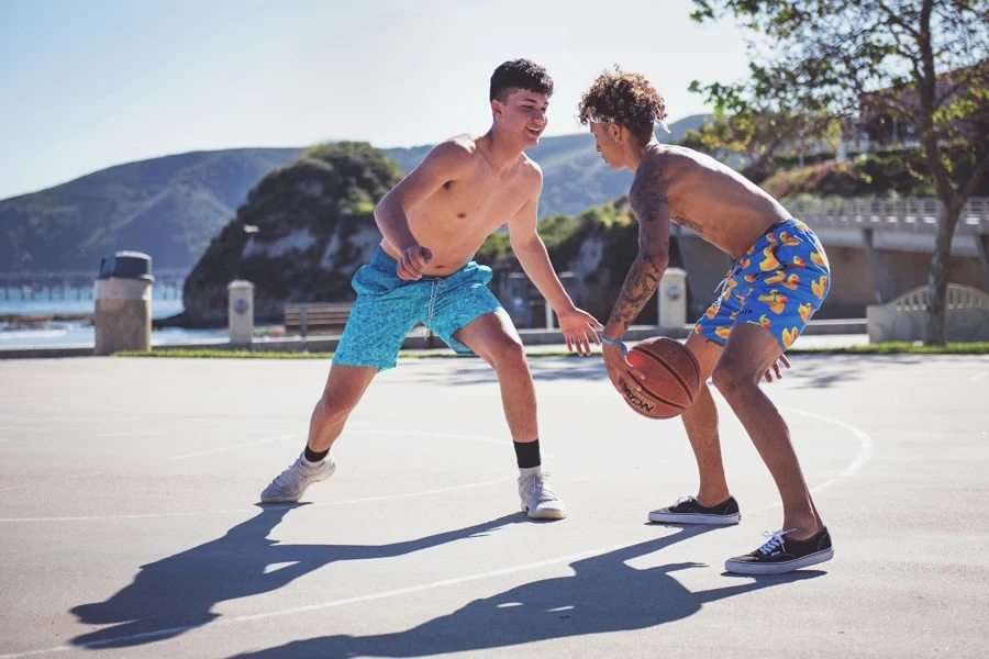 Two men playing basketball outside