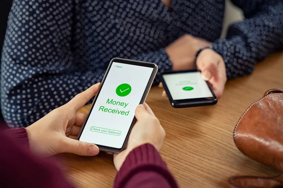 Two people using mobile banking apps