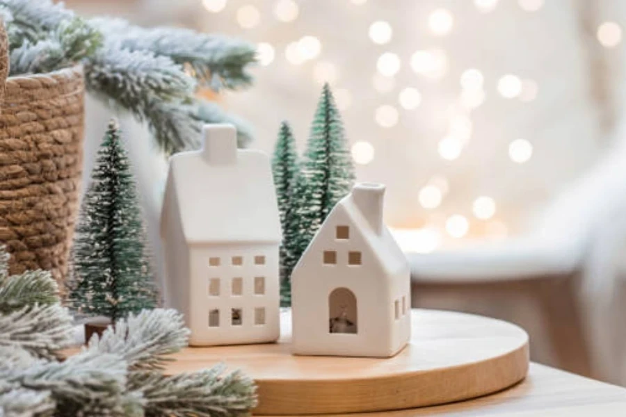 Two white ceramic Christmas village wax melters in modern design