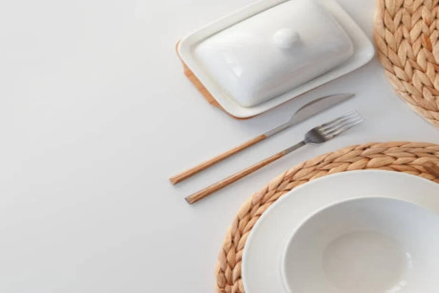 White handmade ceramic butter dish next to minimalist kitchenware