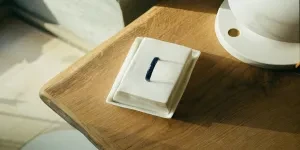 White porcelain butter dish with black handle on lid