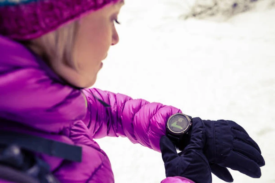 Woman Hiker Checking Sports Watch in Winter