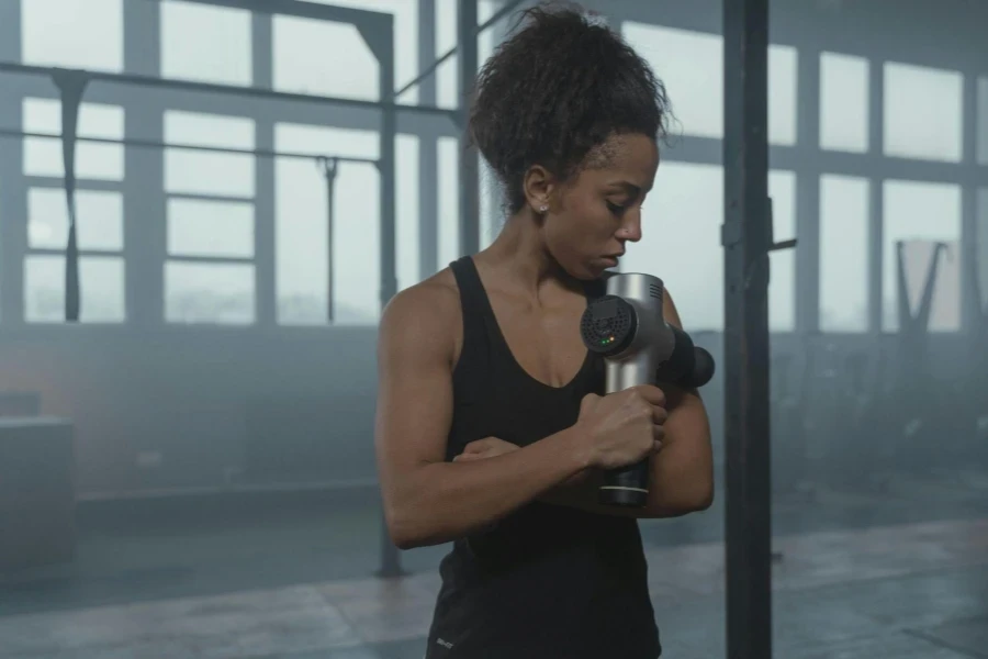 Woman Holding a Massage Gun