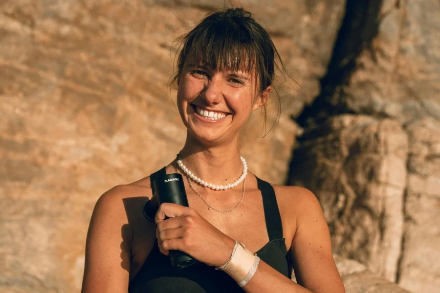 Woman Holding a Massage Gun