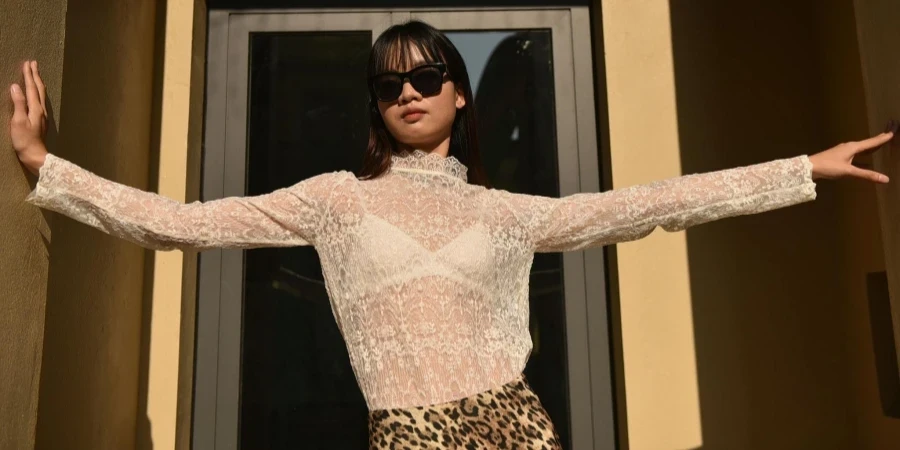 Woman Posing in White Lace Blouse and Leopard Print Skirt